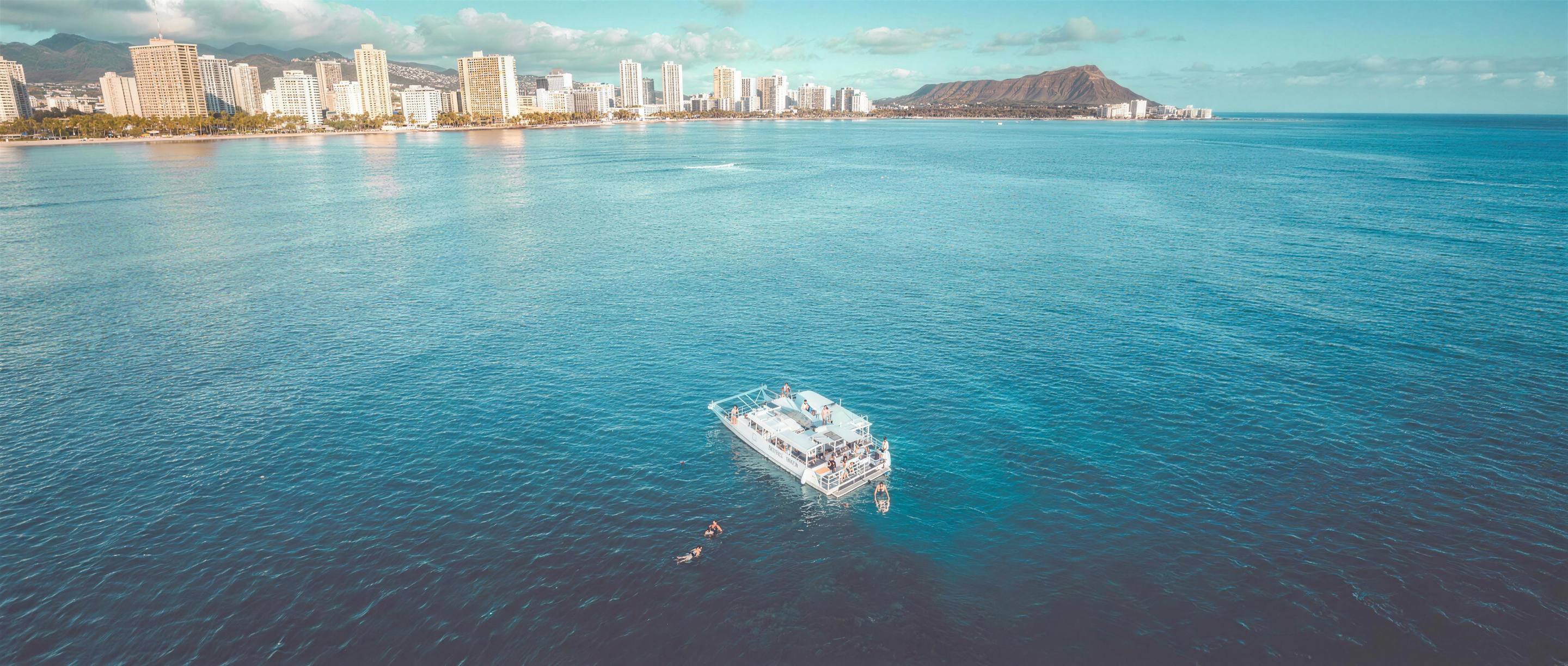 OceanStar boat off Waikiki with Diamond Head behind